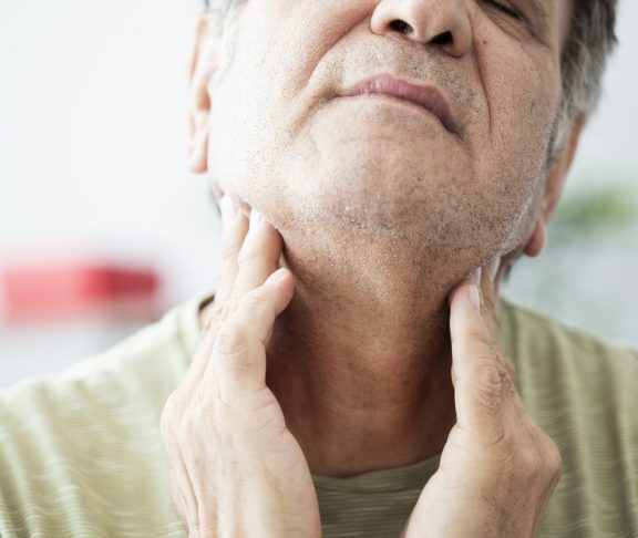 Old man feeling painful in the throat