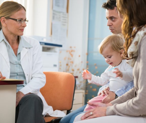 Pediatrician with baby and her Parents.