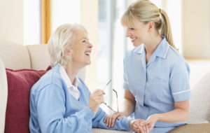 Caregiver talking with older woman