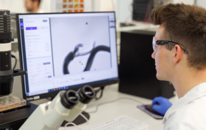 man in lab looking at screen