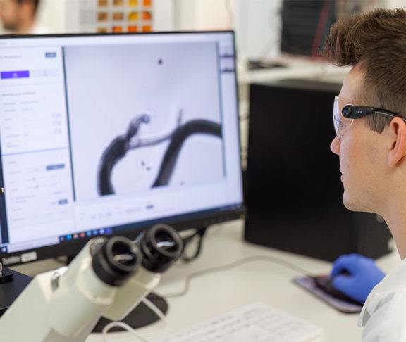 man in lab looking at screen