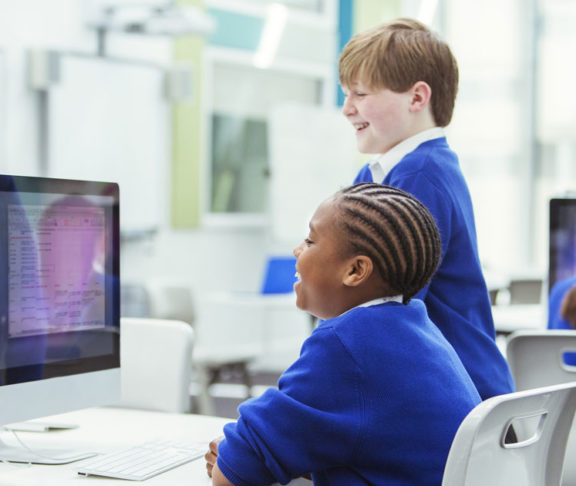 Elementary school children working with computers