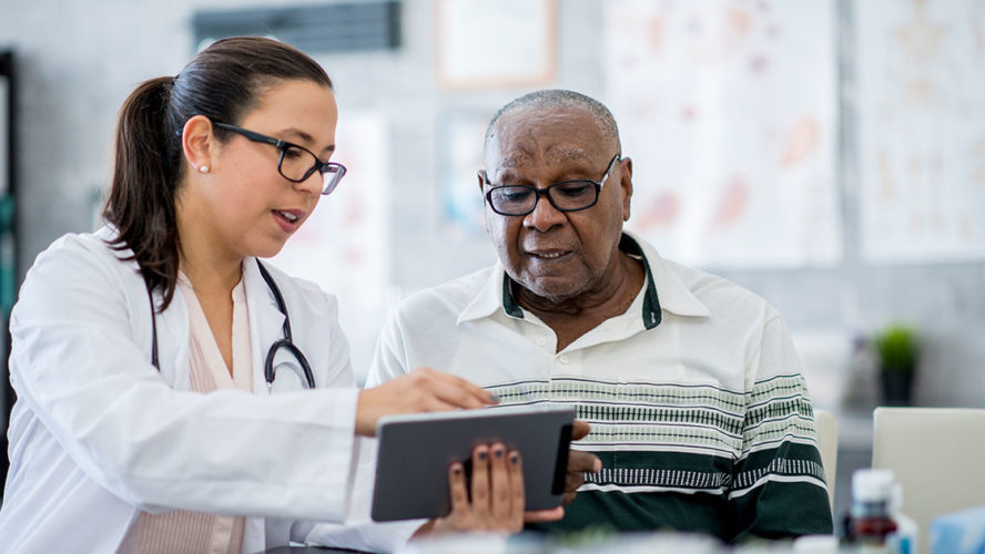 aging-african-american-man-with-doctor-on-tablet