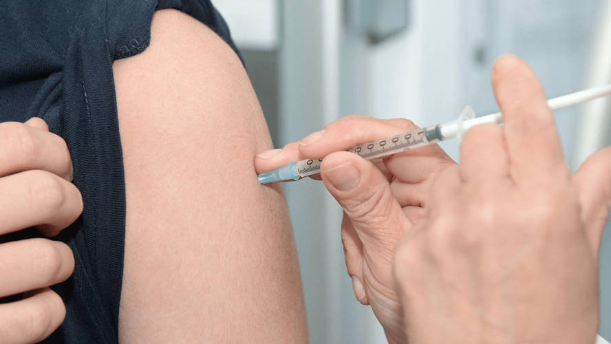 læge giver influenzavaccine til patient