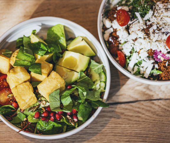 Delicious vegan, gluten free bowls with vegan cheese, chickpea-tofu or falafel and a lot of greens