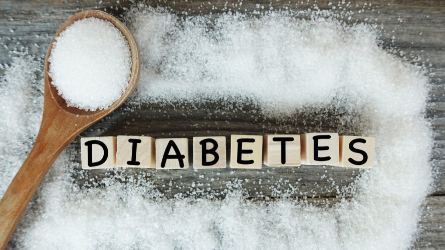 Diabetes word on wooden letters with crystalized white sugar as frame