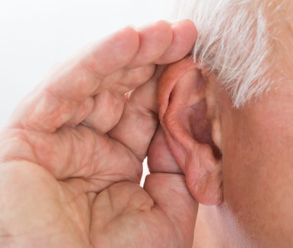 Close-up Of A Senior Man Trying To Hear Hand Over Ear