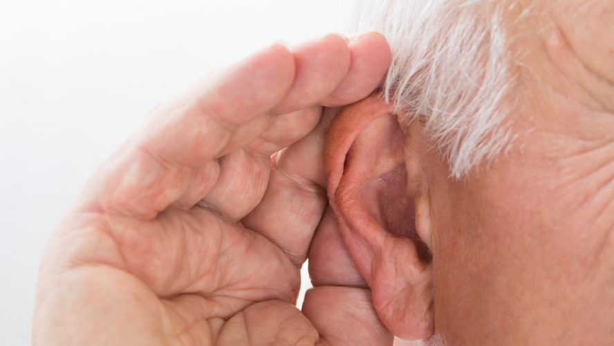 Close-up Of A Senior Man Trying To Hear Hand Over Ear
