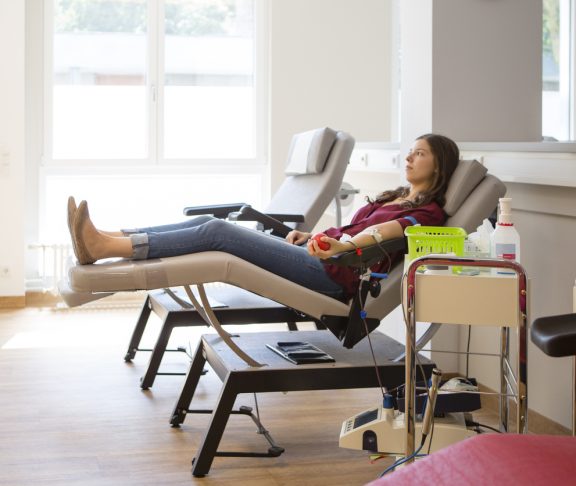 young woman lay on back while she is donating blood
