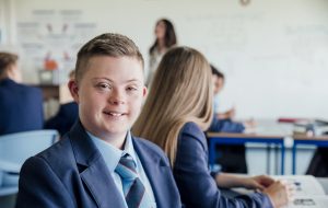 Headshot of down syndrome teenage boy during a lesson.