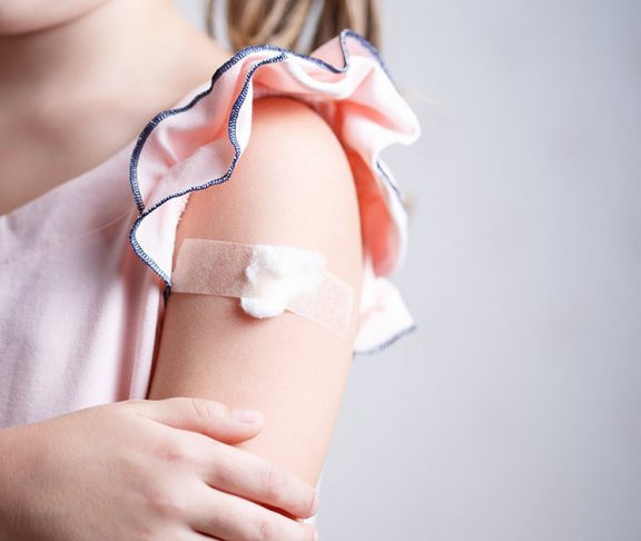 Little girl with bandaid on arm
