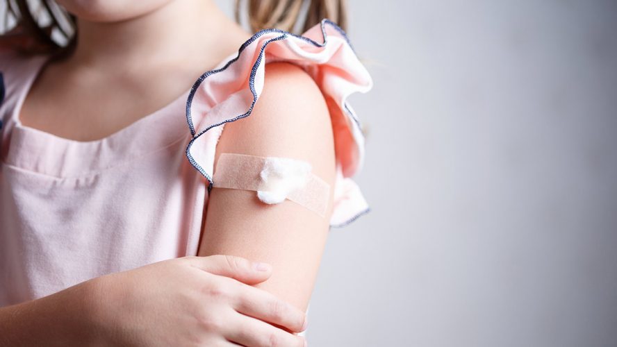Little girl with bandaid on arm